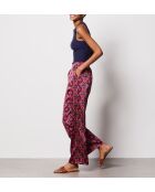Pantalones blancos con estampado de fondo morado