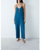 Eleanore jumpsuit uit één stuk gedrukt op een groene achtergrond