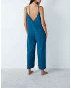 Eleanore jumpsuit uit één stuk gedrukt op een groene achtergrond