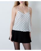 Camiseta sin mangas Elvis con estampado de lunares negros sobre fondo blanco