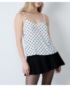 Camiseta sin mangas Elvis con estampado de lunares negros sobre fondo blanco