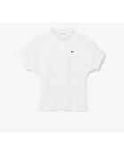 Polo asimmetrica con piqué bianco