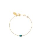 Aurore Armband aus Feingold und besetzt mit einem feinen golden/blauen Stein