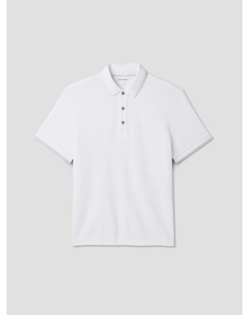 Witte polo met knopen in reliëf