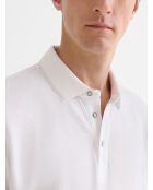 Witte polo met knopen in reliëf