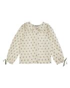 Blusa de algodón color crudo de manga larga con volantes y estampado floral